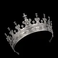Vintage silver Gothic crown with baroque floral carvings on a dark background - Antique Silver