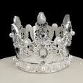 Detailed view of silver crown topper with sparkling rhinestones and white pearls - Silver & White