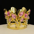 Macro detail of golden crown cake topper with pink teardrop crystals and small rhinestones - Gold + Pink