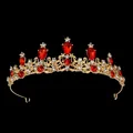 Close-up of golden vintage crown with red water-drop gems and white zircons - Gold Red