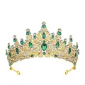 Detailed view of luxury gold bridal crown with deep green emerald stones and diamonds - Gold + Green