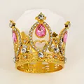 Macro shot of gold alloy mini crown featuring pink teardrop rhinestones and heart cutouts - Gold + Pink
