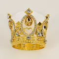 Detail of golden tiara featuring crystal rhinestones and pear-shaped light brown gemstones - Gold + Yellow