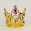 Close-up of golden children crown with purple teardrop gems and heart patterns - Gold + Purple