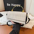 Beige getextureerde crossbodytas met gouden metalen handvat en zwarte schouderriem - Wit