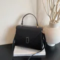 Black pebbled leather tote bag with gold metal buckle and versatile shoulder strap - Black