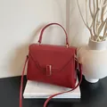 Chic red lychee grain leather tote bag with gold buckle and adjustable strap - Red