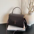 Textured reddish brown leather tote bag with gold hardware and top handle strap - Brown