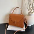 Texture leather tote bag in caramel brown featuring a metal lock and detachable strap - Caramel color