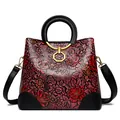 Vintage red crossbody bag with embossed floral pattern and round leather handles - Pink