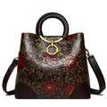 Vintage brown embossed leather handbag with red floral pattern and adjustable strap - Yellow