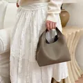 Taupe lychee pattern leather bucket bag with top handle and minimalist slouchy silhouette - Gray