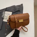 Vintage brown leather crossbody bag with gold rectangular clasp and shell charm detail - Brown