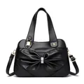 Elegant black handbag with crystal-encrusted bow and golden hardware details - Black
