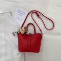 Red lychee grain leather bucket bag with plush bear charm and adjustable shoulder strap - With Pendant / Red