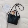 Black lychee leather bucket bag with a cute teddy bear charm and slender shoulder strap - With Pendant / Black