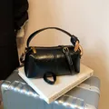 Classic black cylinder pillow bag with glossy finish and bold gold chain handle detail - Black without Pendant