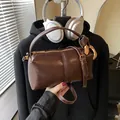 Vintage dark brown oily leather pillow bag with gold ring detail and top handle strap - Coffee without Pendant