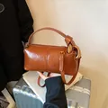 Brown leather cylindrical pillow bag with gold metal rings and adjustable strap - Brown No Pendant