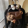 Dark brown leather Boston bag with leopard print heart charm and knot handle detail - Coffee With Pendant