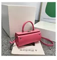 Pink cylindrical top-handle bag in faux leather with silver buckle and shoulder strap - Pink