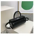 Minimalist black cylinder shoulder bag with silver twist lock and slim strap - Black