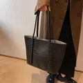Classic black crocodile pattern tote bag with slender handles for a versatile winter look - Black
