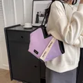 Purple pleated canvas tote bag with woven shoulder strap and black trim details - Purple