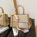 Elegant beige crossbody handbag featuring textured faux crocodile skin and smooth leather - Khaki