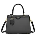 Minimalist grey woven handbag with black leather straps and gold metal hardware accents - Black