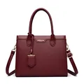 Classic burgundy pebbled leather tote bag with gold logo and adjustable shoulder strap - Red