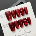 Handmade deep red cat-eye press-on nails with sparkling ruby gemstone accents on card - Wine Red Cat Eye Ruby Gem Short Coffin