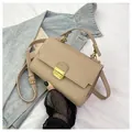 Chic beige lychee leather handbag with gold metal clasp and adjustable shoulder strap - Khaki