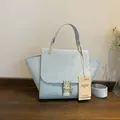 Light blue trapezoid handbag with textured crocodile pattern and gold buckle detail - Sky Blue
