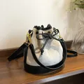 Quilted bucket bag in grey frosted finish with black leather trim and drawstring - Gray