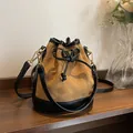 Brown quilted suede bucket bag with black leather trim and drawstring closure - Brown