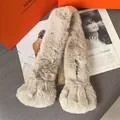 Close-up of a soft beige faux fur scarf with a plush texture and cross-over slit design - Milk Tea