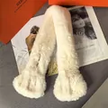 Detail of plush off-white faux fur scarf featuring thick fluffy texture and soft finish - Beige