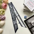 Detailed view of deep blue floral silk twilly scarf with elegant France Paris script - Black Beige