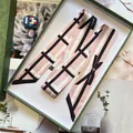 Pink satin twilly scarf with black and white geometric pattern in a green gift box - Pink
