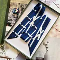 Elegant navy blue geometric twilly silk scarf presented in a luxury green embossed gift box - Bowknot Geometric Style / Blue