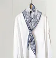 Detailed view of Toile de Jouy silk twilly scarf with blue nature print on white shirt - 45x115cm