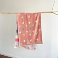 Detail of coral pink houndstooth knit shawl with fringe on a rustic wooden branch - 180cmx65cm / Pink (S1946)