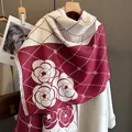 Dettaglio dello scialle spesso camelia con elegante color block e bordo a frange - Rosso