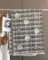 Close-up of elegant rose flower pattern on black and white plaid wool scarf with fringes - Light Gray
