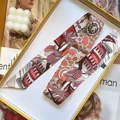 Macro shot of 100% silk twilly scarf with abstract floral print in a gift box - 5cmx90cm / Red