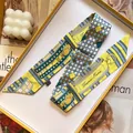Silk-like long twilly scarf with vintage pattern in orange gift box on white candle background - Neon Yellow