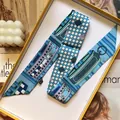 Blue silk-like twilly scarf with check print in a luxury orange gift box setup - Sapphire Blue