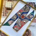 Detailed pattern of colorful silk twilly scarf with Pegasus text in a luxury gift box - Dark Brown