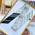 Narrow silk-like scarf with black and white geometric patterns in a yellow gift box - 5x90cm / Off White